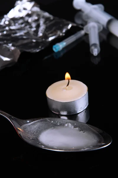 Heroin in spoon on black background — Stock Photo, Image