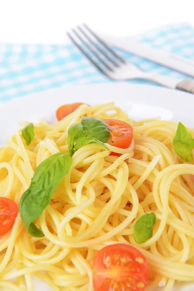 Delicious spaghetti with tomatoes on plate on table close-up — Stock Photo, Image