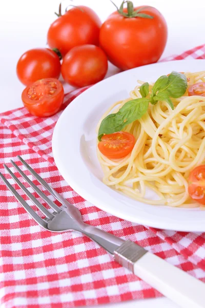 Delicious spaghetti with tomatoes on plate on table close-up — Stock Photo, Image