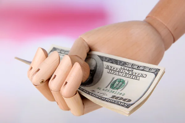 Money in wooden hand, on light background — Stock Photo, Image