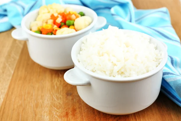 Cooked rice with vegetables on wooden table close up — Stock Photo, Image