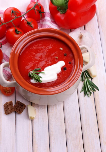 Tasty tomato soup and vegetables on wooden table — ストック写真