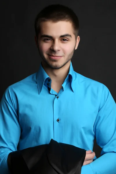 Handsome young man in suit on dark background — Stock Photo, Image