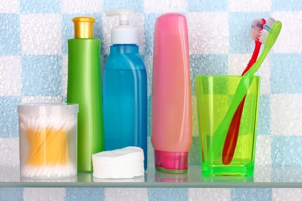 Shelf with cosmetics and toiletries in bathroom — Stock Photo, Image