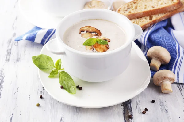Mushroom soup in white pots, on napkin, on wooden background — Stock Photo, Image