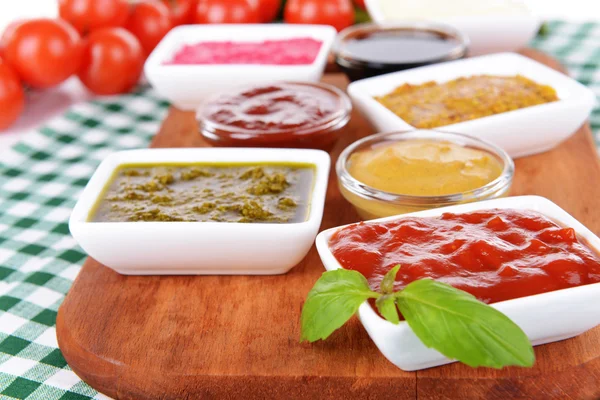 Various sauces on chopping board on table close-up — Stock Photo, Image