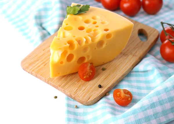 Stück Käse und Tomaten, auf Holzbrett, isoliert auf weiß — Stockfoto