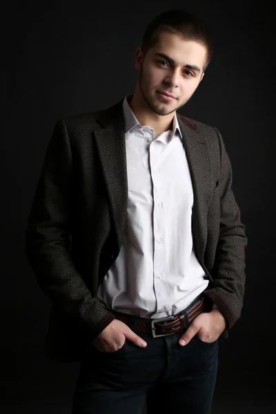 Handsome young man on dark background — Stock Photo, Image