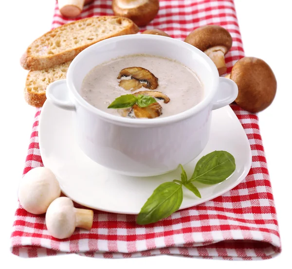 Mushroom soup in white pot, on napkin, isolated on white — Stock Photo, Image