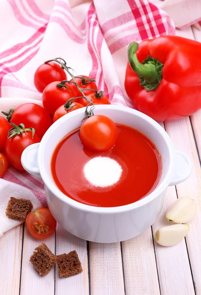 Tasty tomato soup and vegetables on wooden table — Stock Photo, Image