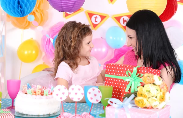 Pretty little girl with mom celebrate her birthday — Stock Photo, Image