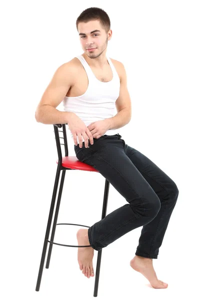 Stilig ung man sitter på stol isolerad på vit — Stockfoto