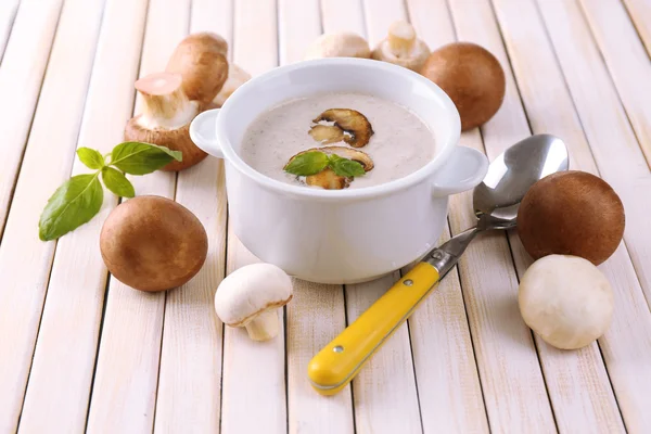 Mushroom soup in white pot on wooden background — Stock Photo, Image