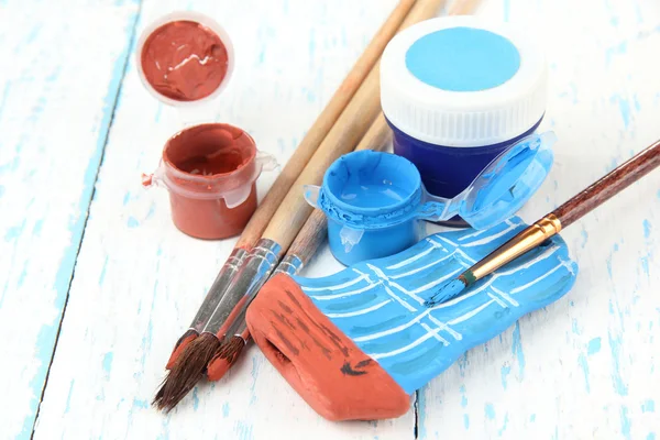 Ręcznie wykonane ceramiczne statku i kolor farby na drewnianym stole — Zdjęcie stockowe