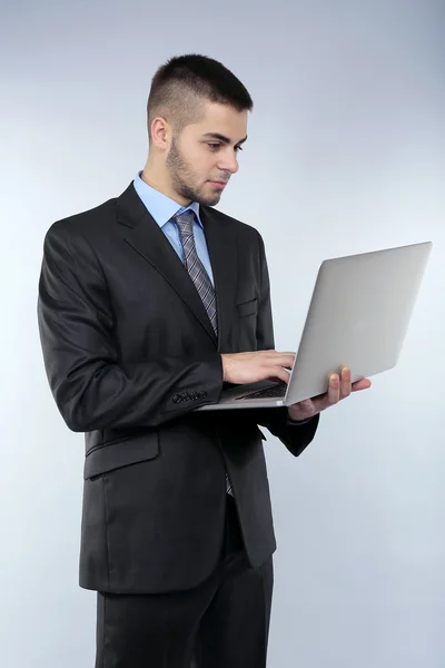 Business man on grey background — Stock Photo, Image