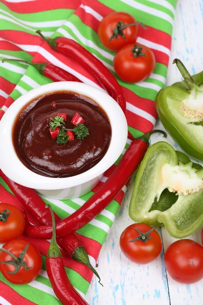 Tomato sauce in bowl on wooden table close-up — Stock Photo, Image