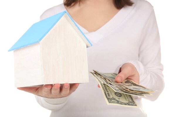 Small wooden house in hands isolated on white