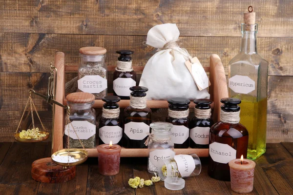 Historic old pharmacy bottles with label and Old-fashioned weight scales, on wooden background — Stock Photo, Image