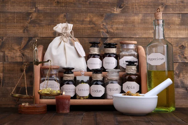 Historic old pharmacy bottles with label and Old-fashioned weight scales, on wooden background — Stock Photo, Image