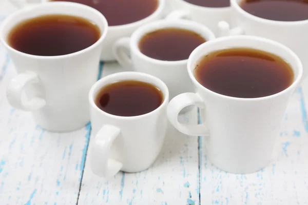 Many cups of tea on table close-up — Stock Photo, Image