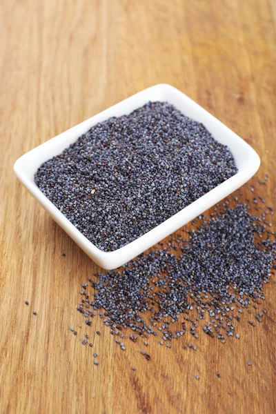 Poppy seeds in bowl on table close-up — Stock Photo, Image