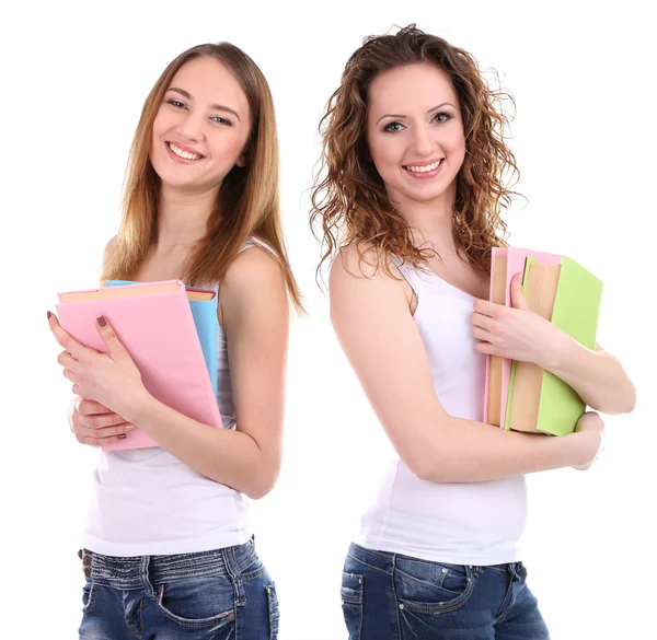 Hermosas mujeres jóvenes sosteniendo libros aislados en blanco — Foto de Stock