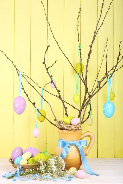 Easter composition with eggs branches on wooden background — Stock Photo, Image