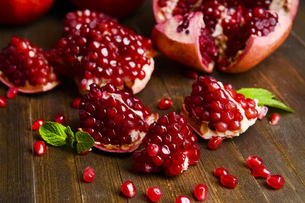 Ripe pomegranates on table close-up — Stock Photo, Image