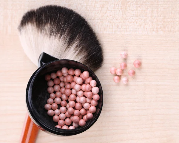 Powder balls on wooden background Stock Picture