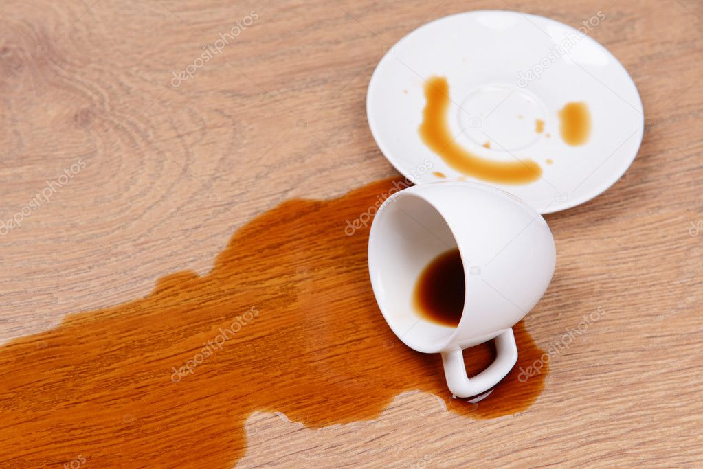 Overturned cup of coffee on floor close-up