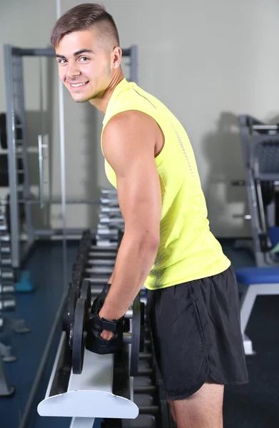 Guy with dumbbells in gym — Stock Photo, Image