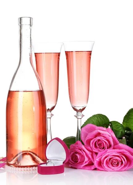 Composition with pink sparkle wine in glasses, bottle and pink roses isolated on white — Stock Photo, Image