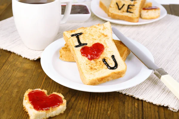 Delicious toast with jam and cup of tea on table close-up — Stock Photo, Image