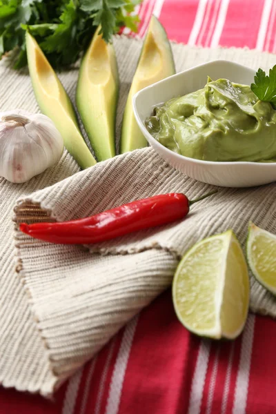 Fresh guacamole in bowl on table — Stock Photo, Image