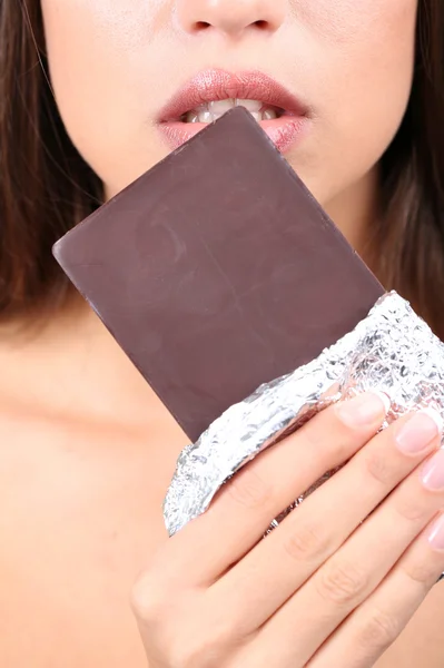 Closeup of woman eating chocolate Stock Image