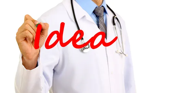 Doctor writing word Idea on transparent board — Stock Photo, Image