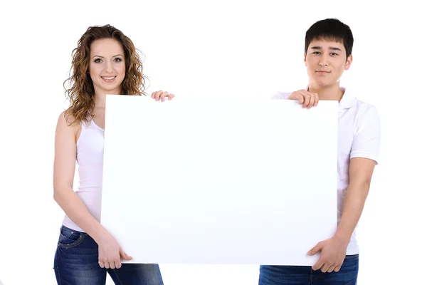 两个漂亮的年轻人抱着空白海报上白色孤立 — 图库照片