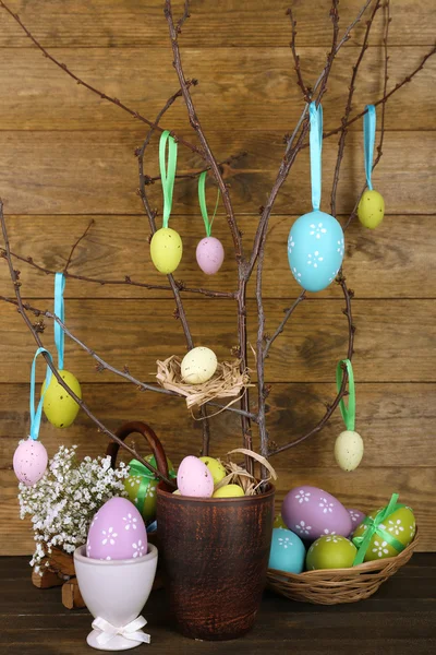 Easter composition with eggs branches on wooden background — Stock Photo, Image