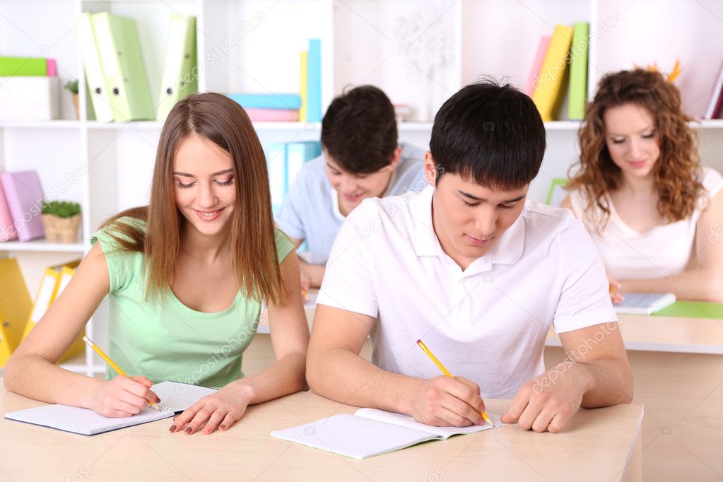 Group of young students sitting in class