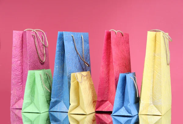 Bolsas de compras coloridas, sobre fondo de color — Foto de Stock