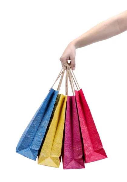 Bolsas de compras coloridas en mano femenina, aisladas en blanco — Foto de Stock