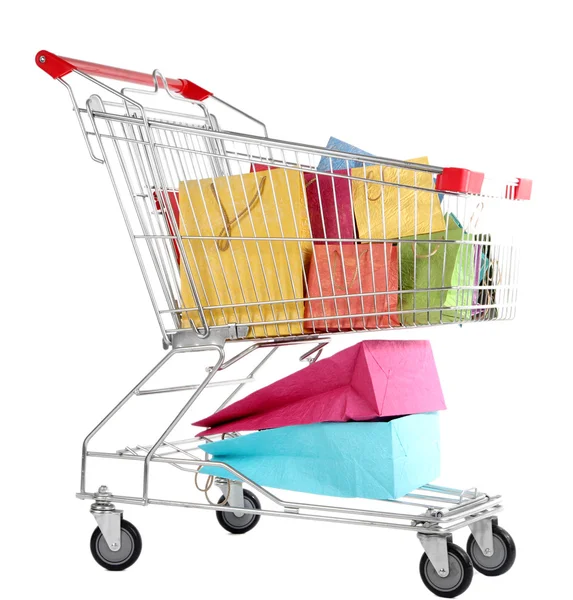 Colorful shopping bags in shopping trolley, isolated on white — Stock Photo, Image