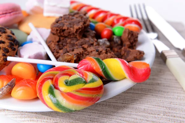 Olika sötsaker på tallriken på bordet närbild — Stockfoto