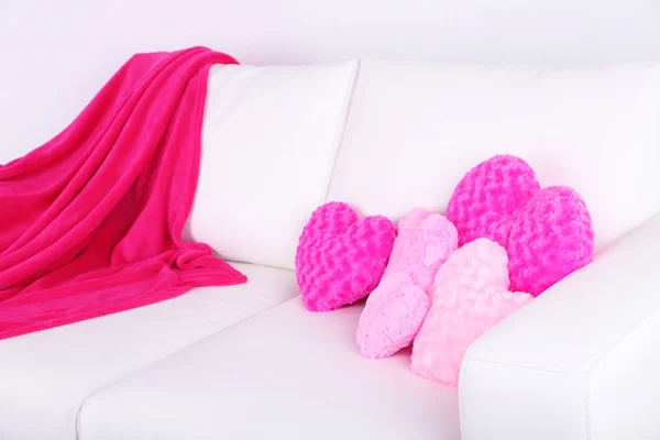 Pink heart shaped pillows on white sofa — Stock Photo, Image