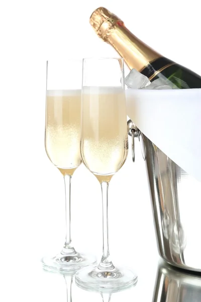 Glasses of champagne and bottle in pail, isolated on white — Stock Photo, Image