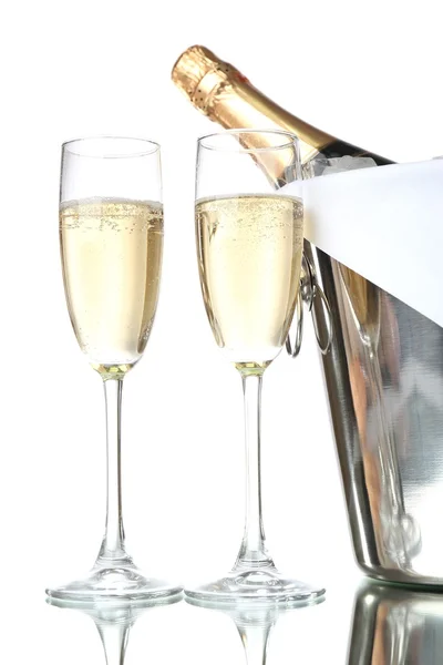 Glasses of champagne and bottle in pail, isolated on white — Stock Photo, Image