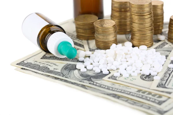 Prescription drugs on money background representing rising health care costs. Isolated on white — Stock Photo, Image