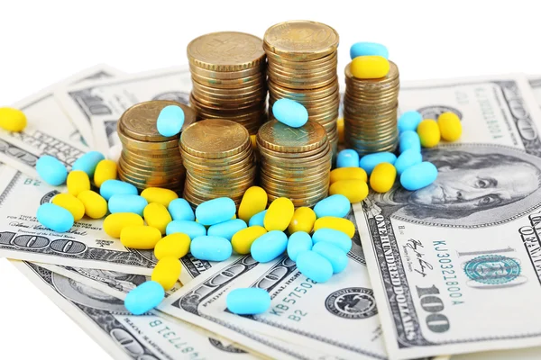 Prescription drugs on money background representing rising health care costs. Isolated on white — Stock Photo, Image