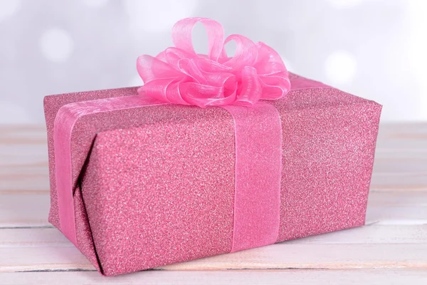 Gift box on table on light background