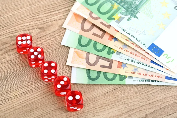 Red dices and money, on wooden background — Stock Photo, Image